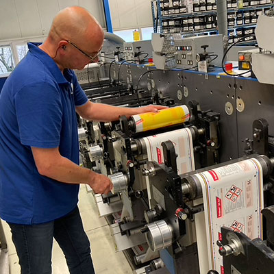 man changing press on flexo printer