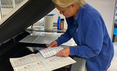 woman inspecting quality of labels